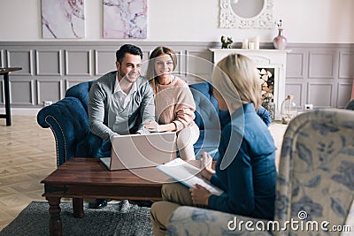 Successful agent giving consultation to family couple about buying house. Stock Photo