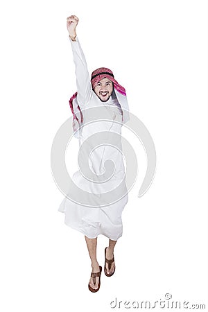 Successful Arabian man jumping in studio Stock Photo