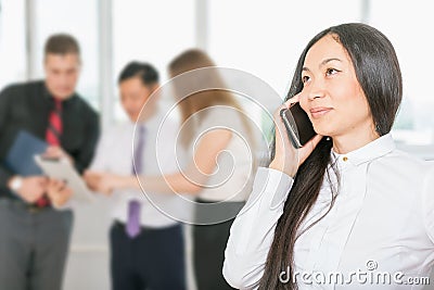 Successful asian business woman using mobile phone Stock Photo