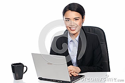 Successful Asian businesswoman at her desk Stock Photo