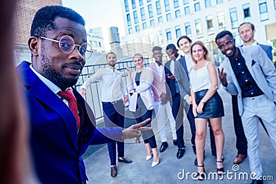Successful and beautiful American afro man in a business suit in a white shirt looking into the phone and takes photos Stock Photo