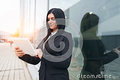 Successful business woman working with tablet in an urban setting Stock Photo