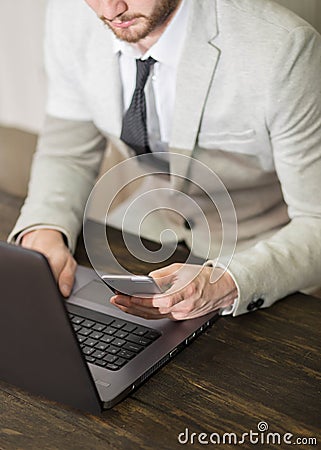 Successful businessman checking his bank account on his cellpone Stock Photo