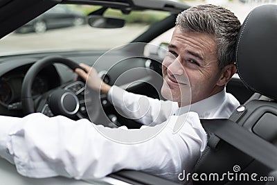 Successful businessman driving his car Stock Photo