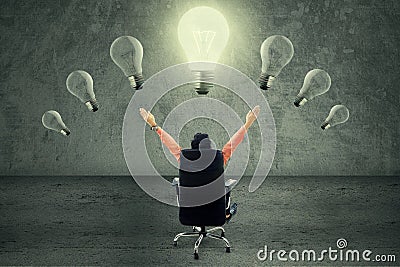 Successful businessman under lightbulb Stock Photo