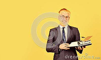Successful businessman use retro typewriter. mature man dyed beard hair. professional typist make notes. modern and old Stock Photo
