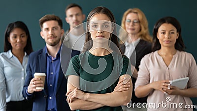 Successful businesswoman posing with multiracial colleagues in office Stock Photo