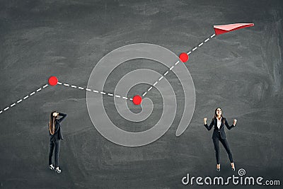 Successful businesswomen with creative flying paper plane chart on chalkboard wall background. Growth and success concept Stock Photo