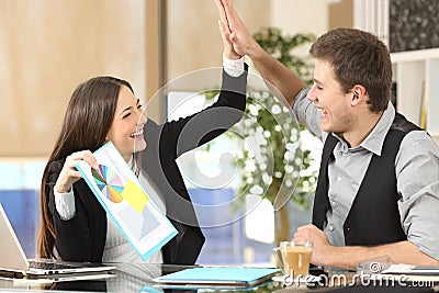 Successful coworkers celebrating good results Stock Photo