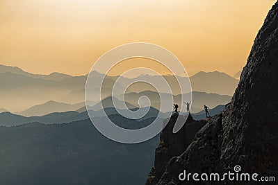 Successful, determined and challenging people at the top of the mountains Stock Photo