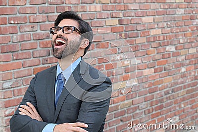 Successful excited business man happy smile looking up to empty copy space, handsome young businessman surprise with arms crossed Stock Photo