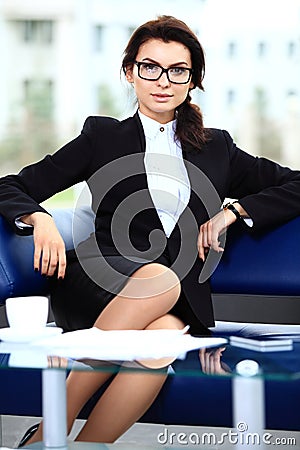 Successful female sitting in office Stock Photo