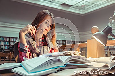 Successful Girl Studying Hard in Library Stock Photo