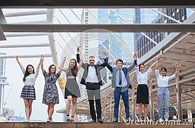 Successful group of business people,Success achievement hand raised,Team work to achieve goals Stock Photo