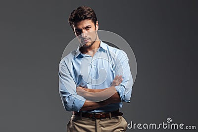 Successful handsome man with arms folded standing Stock Photo