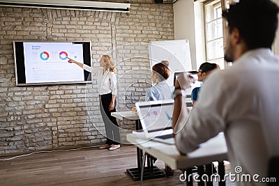 Successful happy group of people learning software engineering and business during presentation Stock Photo