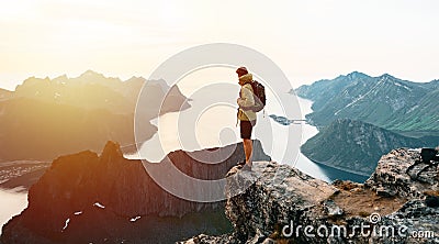 Successful hiker hiking on seaside mountain peak. Editorial Stock Photo