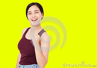 Successful korean,asian woman isolated on yellow background,girl show gesture of success positive sign thumbs yes Stock Photo