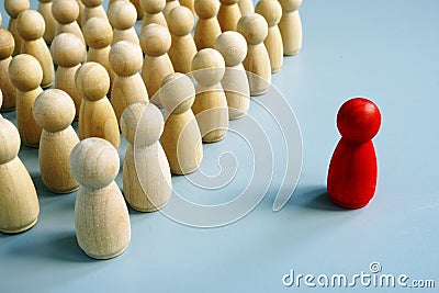 Successful leader of team as red figurine out of the crowd Stock Photo