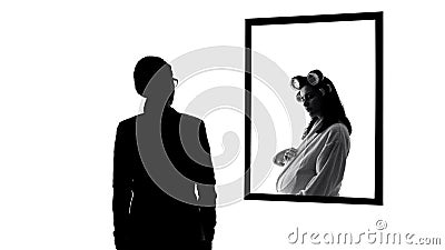 Successful but lonely business woman wishing to be pregnant, mirror reflection Stock Photo