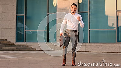 Successful lucky arabic indian business man boss leader candidate entrepreneur with briefcase standing in city near Stock Photo