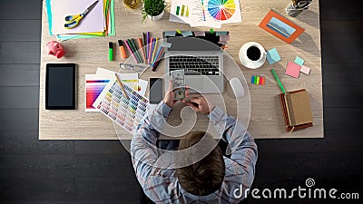 Successful male interior designer counting money, received high wage for project Stock Photo