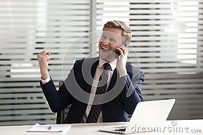 Successful manager talking on phone, celebrating new corporate client attracting. Stock Photo