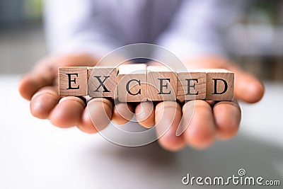 Successful Overachiever Man With Exceed Blocks Stock Photo