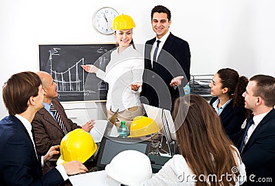 Successful professionals with laptops and helmets Stock Photo