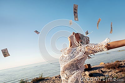 Successful prosperous freelancer throwing her money in the air Stock Photo