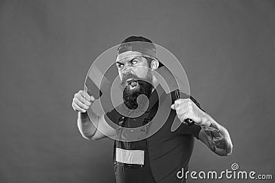 Successful renovation. Bearded man worker with plastering tools. Plasterer hipster builder in cap red background Stock Photo