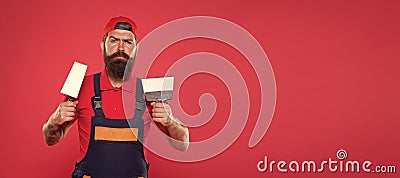 Successful renovation. Repair success. Bearded man worker with plastering tools. Plasterer hipster builder in cap red Stock Photo