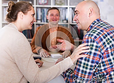Successful seller and buyers at table in office Stock Photo