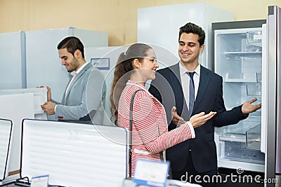 Successful seller and happy couple at household appliances sec Stock Photo