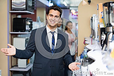 Successful seller and happy couple at household appliances sect Stock Photo