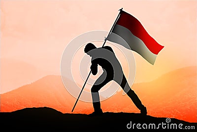 Successful silhouette man waving Indonesian flag on the mountain Stock Photo