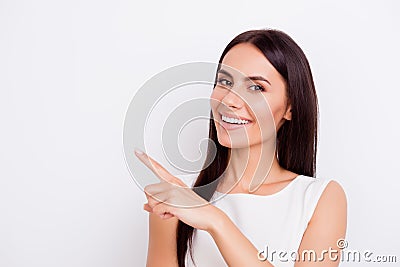 Successful smiling businesslady is pointing away with finger. Sh Stock Photo