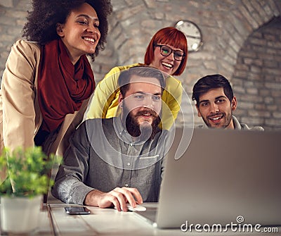 Successful teamwork- young web designers cheering at computer Stock Photo