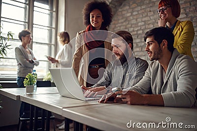 Successful teamwork- young web designers working Stock Photo