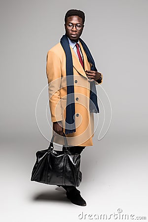 Successful young afro american business executive in coat isolated on white background Stock Photo