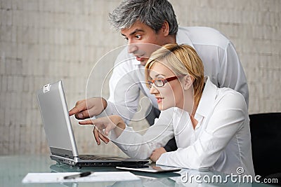 Successful young businesspeople with laptop Stock Photo