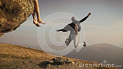 Succsses. Man hipster jumping on mountain on blue sky Stock Photo