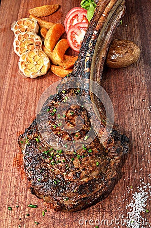 Succulent grilled tomahawk beef steak Stock Photo