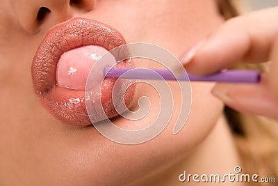 Sucking pink lollipop Stock Photo