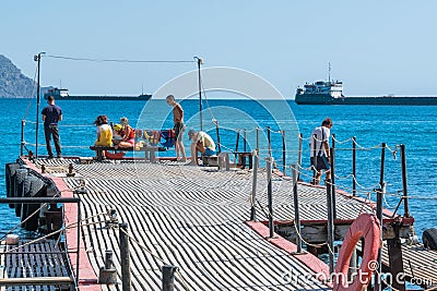 Young people on the sea pier Editorial Stock Photo