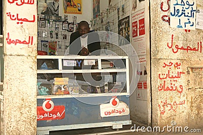 A Sudanese refugee in his mobile phone shop Editorial Stock Photo
