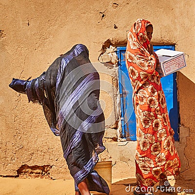 Sudanese women in typical Sudanese clothes shopping in a small village in the desert Editorial Stock Photo