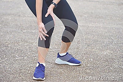 Suffering young runner with leg injury stand on floor Stock Photo