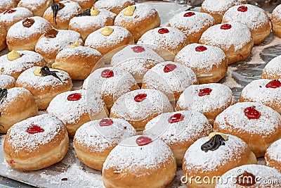 Sufganiot traditional jelly doughnut , bismark covered with powdered sugar eaten during the Hannukah holiday at the Mahane Yehuda Stock Photo