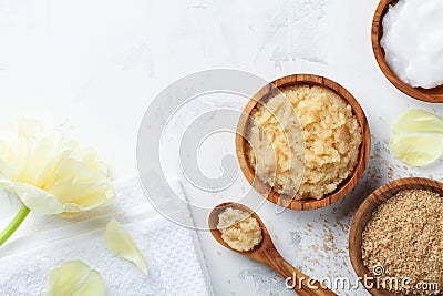 Sugar body scrub with ingredients on white stone table. Homemade cosmetic for spa Stock Photo
